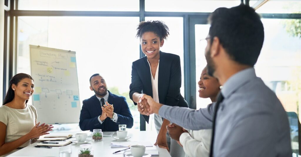 group of people in a business meeting, shaking hands